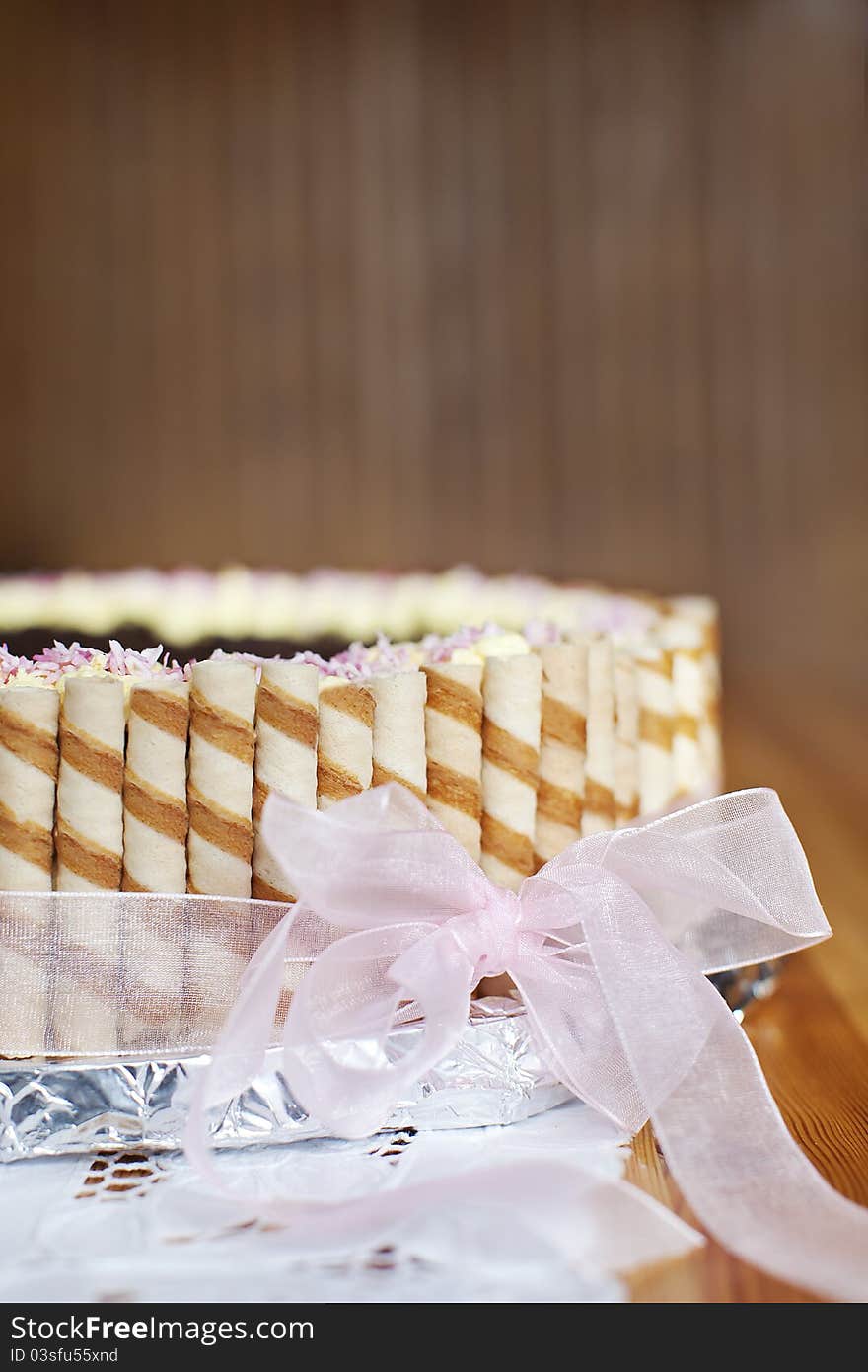 An oryginal birthday cake with pink ribbon