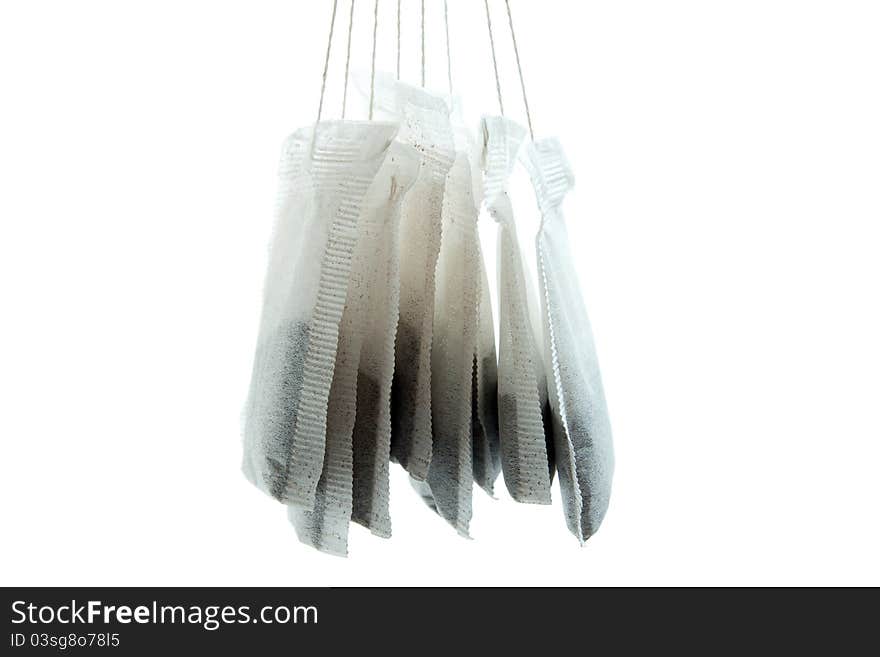 Hanged a couple of tea bag with white background in Close Up. Hanged a couple of tea bag with white background in Close Up