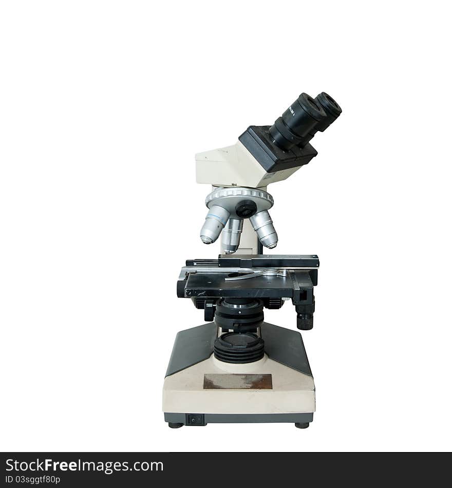 An old-fashioned microscope isolated over white