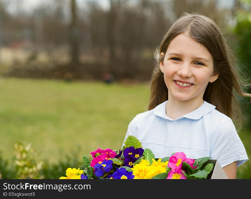 Girl holding the box with colorful pansy flower. Girl holding the box with colorful pansy flower