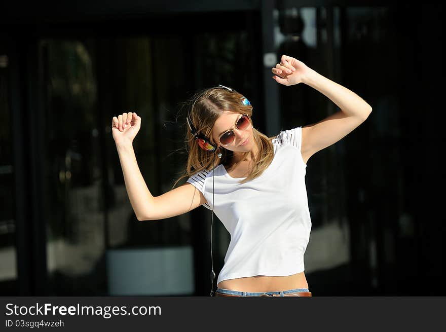 Young girl with headphones in the street