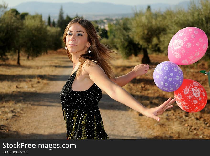 Girl with balloons in the field in Granada