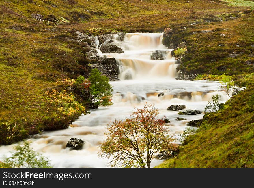 Mountain stream engorged after heavy rainfall with blurred water. Mountain stream engorged after heavy rainfall with blurred water