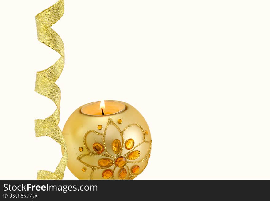 Candle with Christmas decorations and a golden ribbon at the bottom, on white background. Candle with Christmas decorations and a golden ribbon at the bottom, on white background