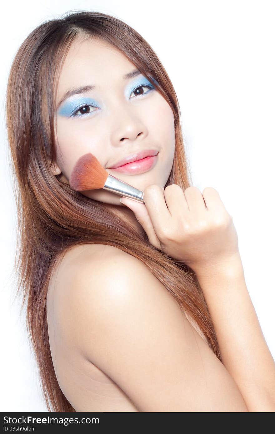 Beautiful young asian woman with make up brush