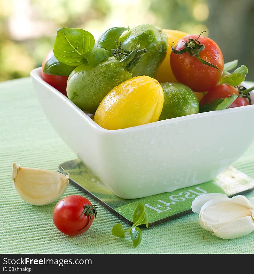 Different fresh tomato in bowl. Selective focus