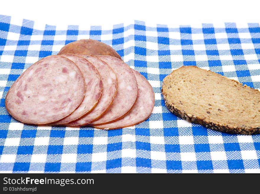 Bread with skin stomach on checked napkin. Bread with skin stomach on checked napkin