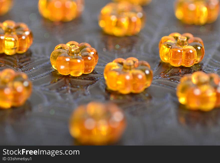 Shiny crystal pumpkins on a cobweb background. Shiny crystal pumpkins on a cobweb background