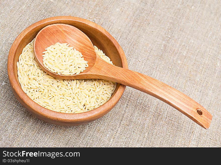 Rice in wooden plate with a spoon