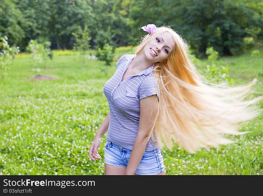 Sexy young female smiling in a park