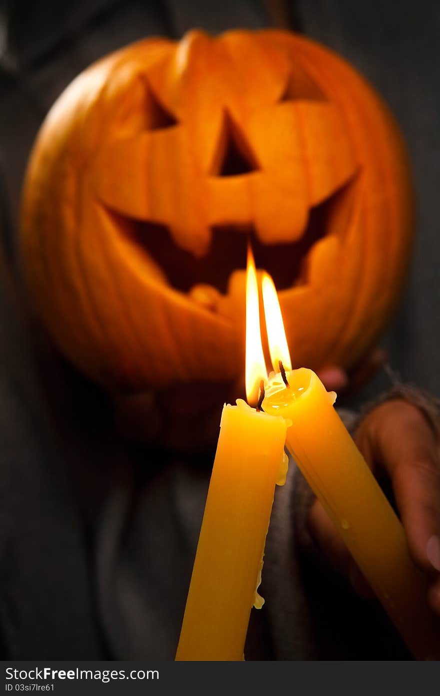 Mystic shoot - halloween glowing pumpkins with two glowing candles in darkness