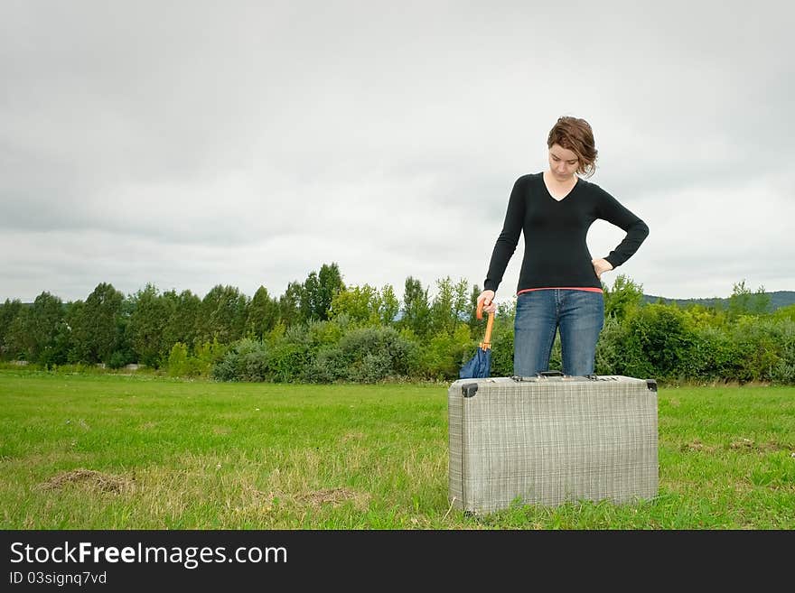 Traveler woman having a rest on the grass. Traveler woman having a rest on the grass