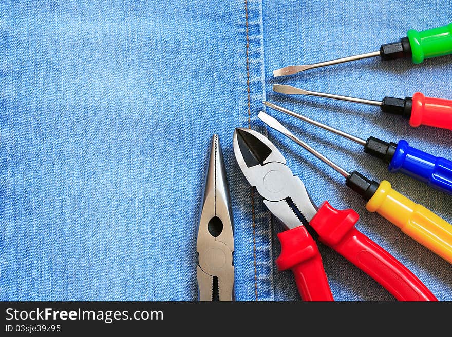 Set of color various work tools on blue denim surface. Set of color various work tools on blue denim surface