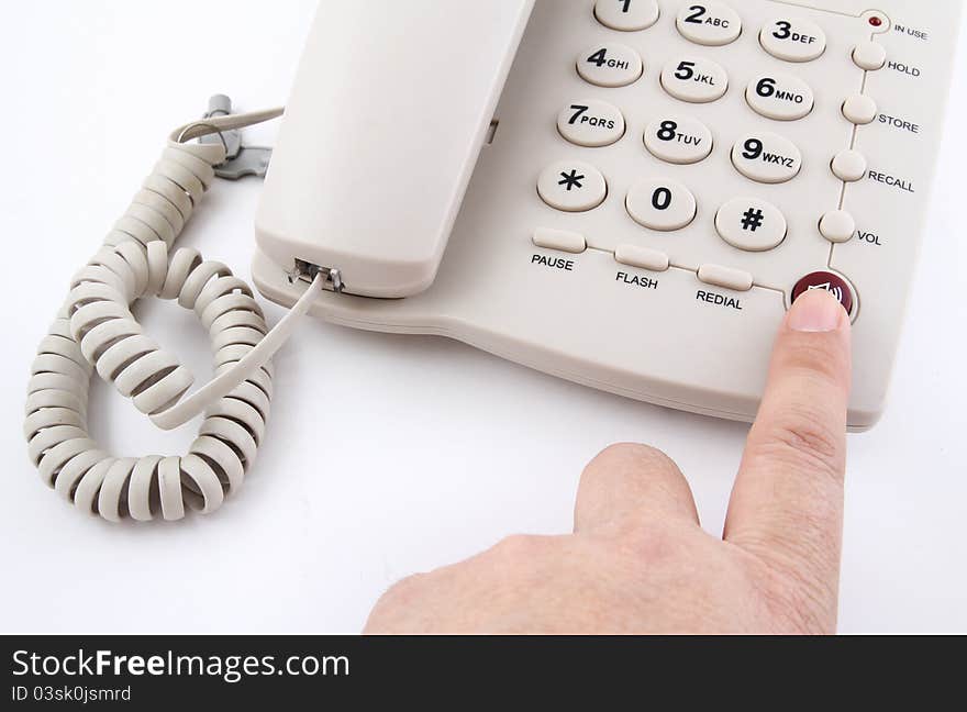 Closeup finger push on red speaker phone button office telephone on white background. Closeup finger push on red speaker phone button office telephone on white background