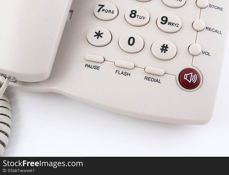 Closeup of a white office telephone on white background