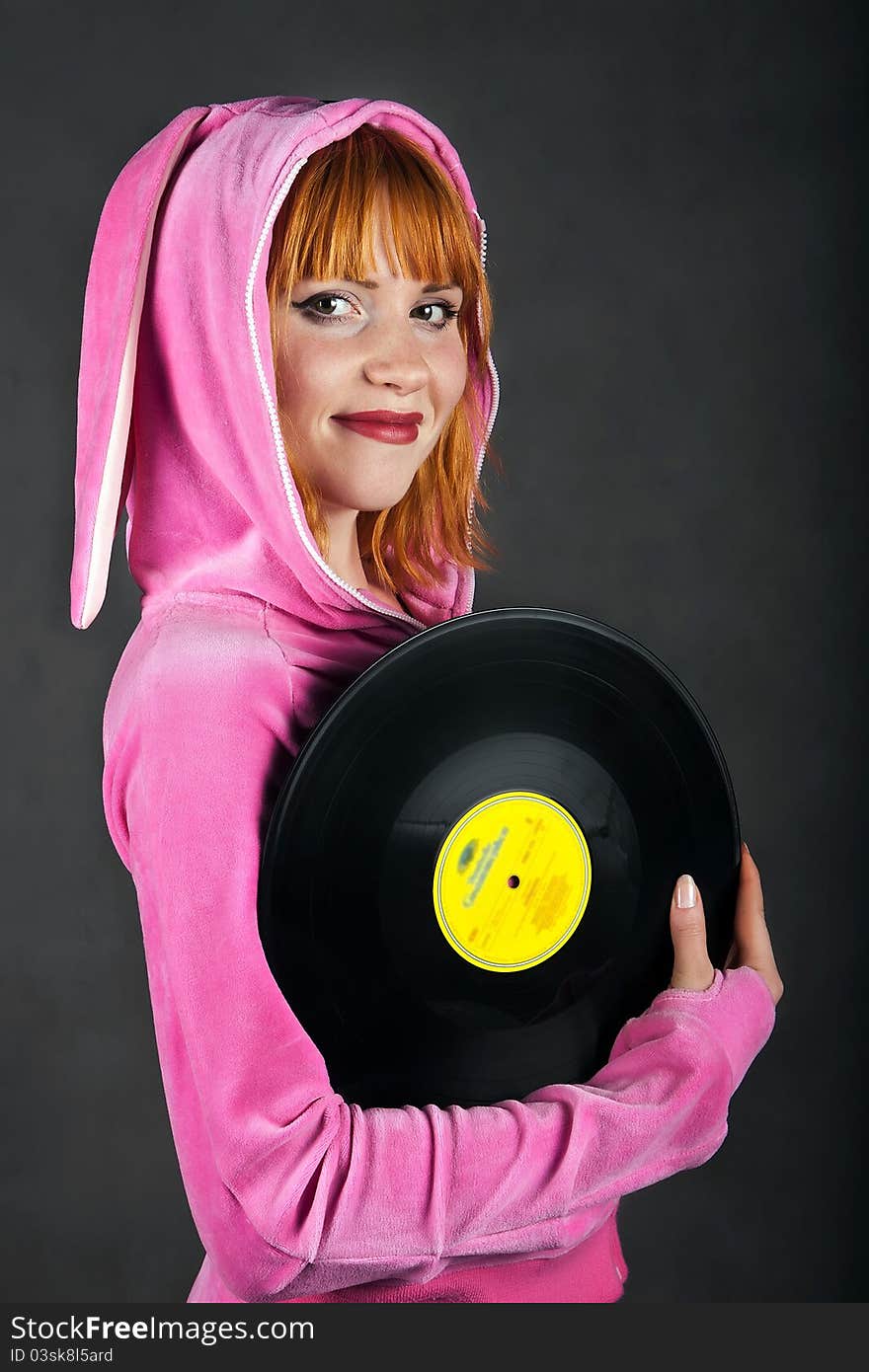 Cute young pretty girl in stylish pink wear with gramophone record. Cute young pretty girl in stylish pink wear with gramophone record