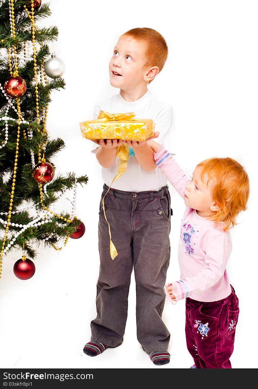 Children decorate a new-year tree on a white background