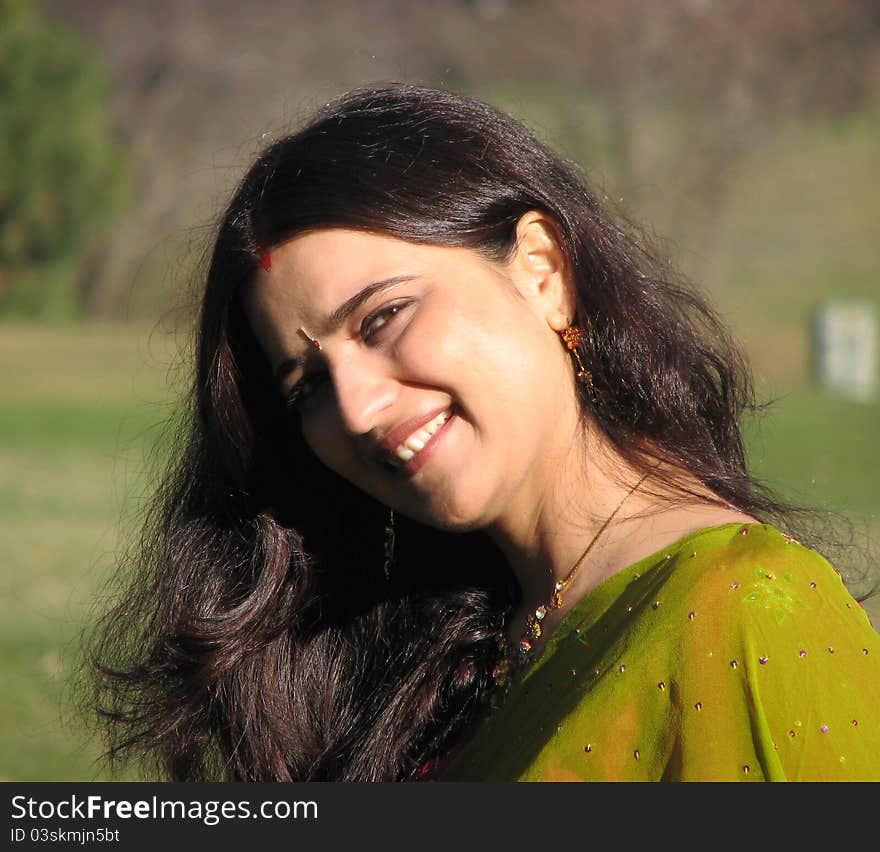 Beautiful Young Indian Married woman in traditional dress and jewelry smiling. Beautiful Young Indian Married woman in traditional dress and jewelry smiling.