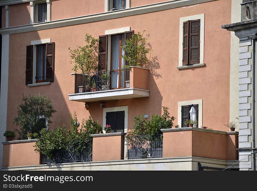 Flowers on balcony on a red building. Flowers on balcony on a red building