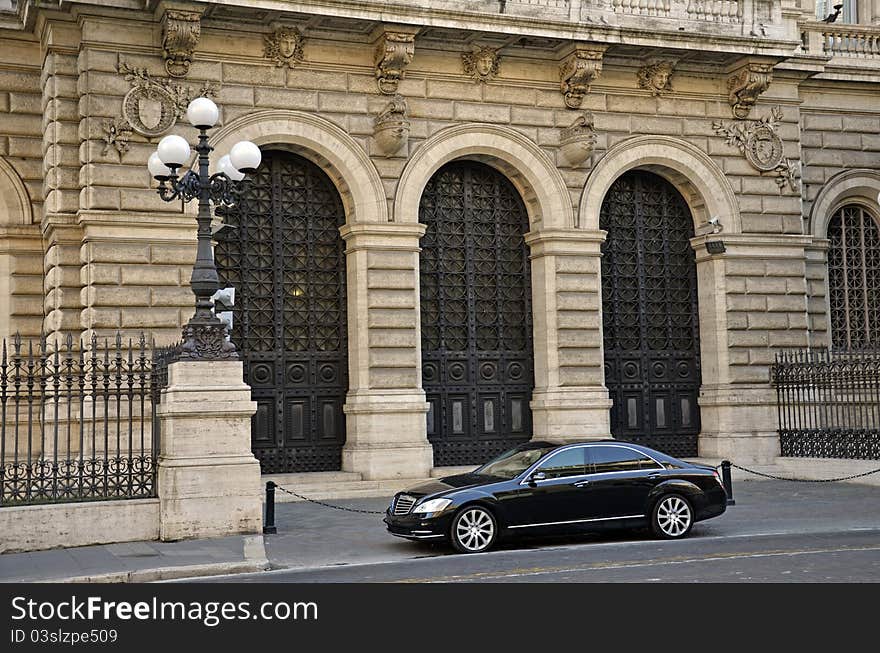 Luxury car waiting in front of a modern building