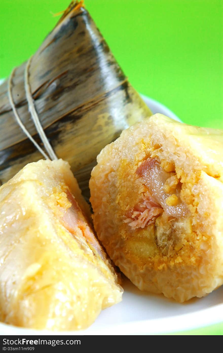 Traditional Chinese rice puddings on green background