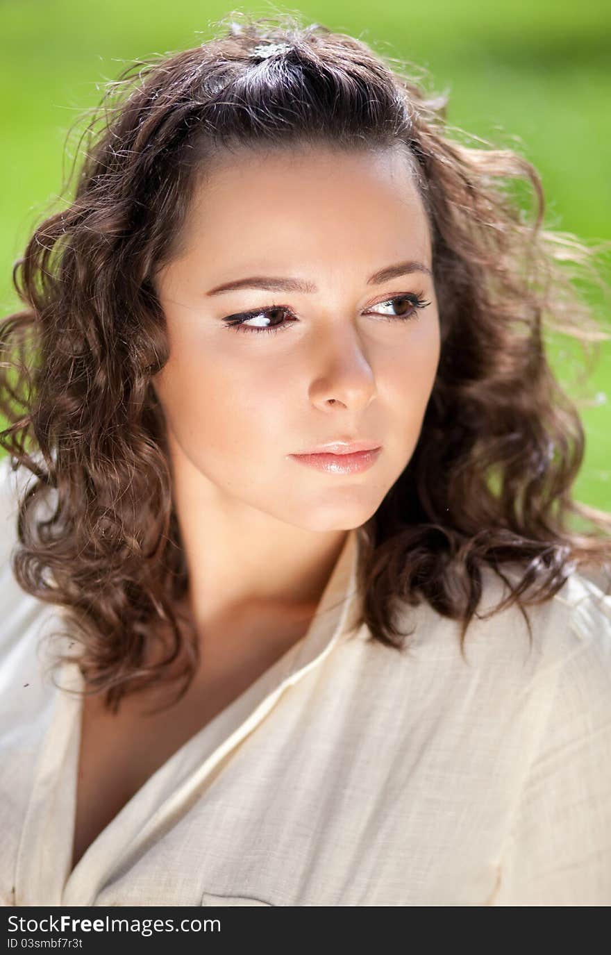 Beautiful girl seating on the grass. Beautiful girl seating on the grass.