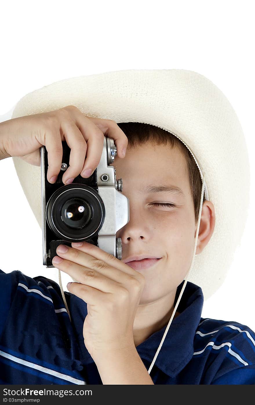 The young teenager in a white hat holds photographs, holding the camera before itself. The young teenager in a white hat holds photographs, holding the camera before itself