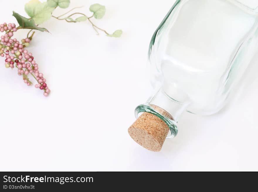 Glass bottle and grapes, on white background