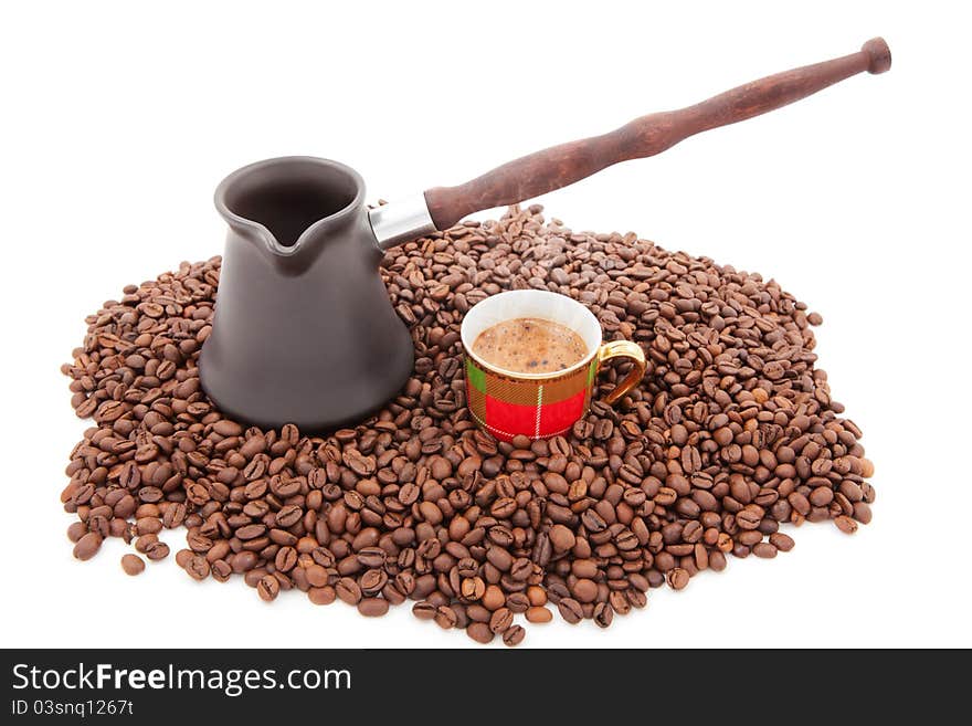 Cup of fresh coffee against coffee grains