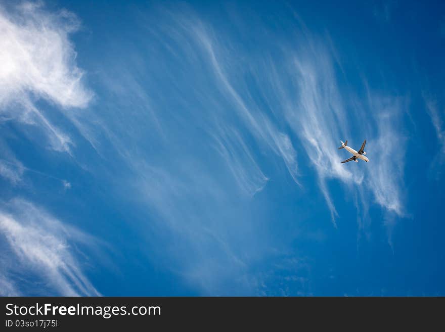 Flying airplane in the blue sky. Flying airplane in the blue sky