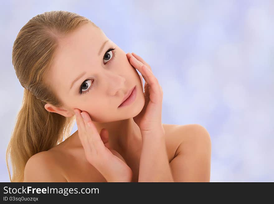 Portrait of a beautiful healthy girl on a light blue background