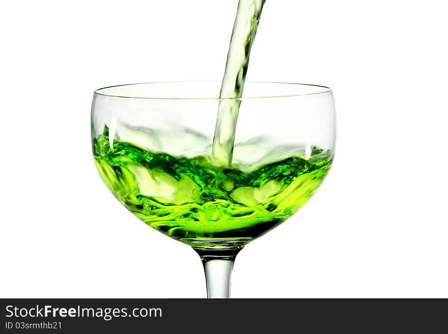 Green martini cocktail into glass on white backgro