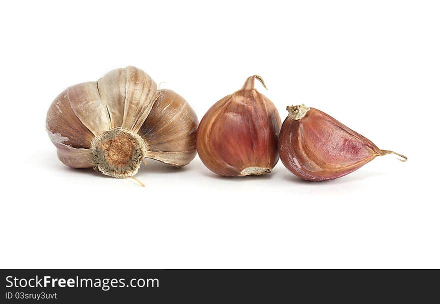 Few cloves of garlic on white background