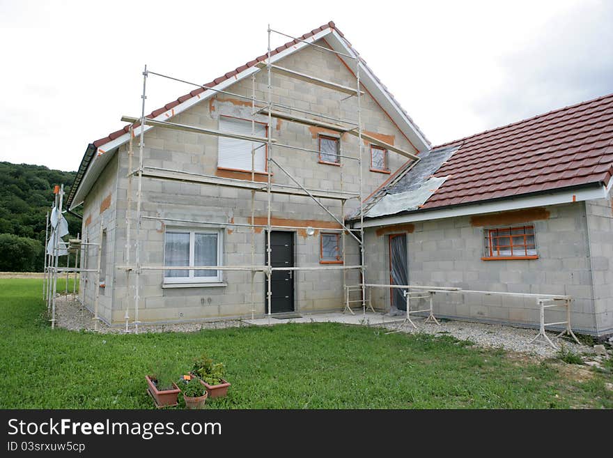 Home with a scaffold to the plaster. Home with a scaffold to the plaster