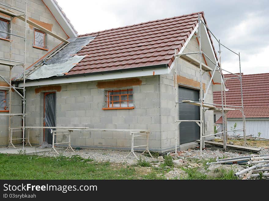 Home with a scaffold to the plaster. Home with a scaffold to the plaster