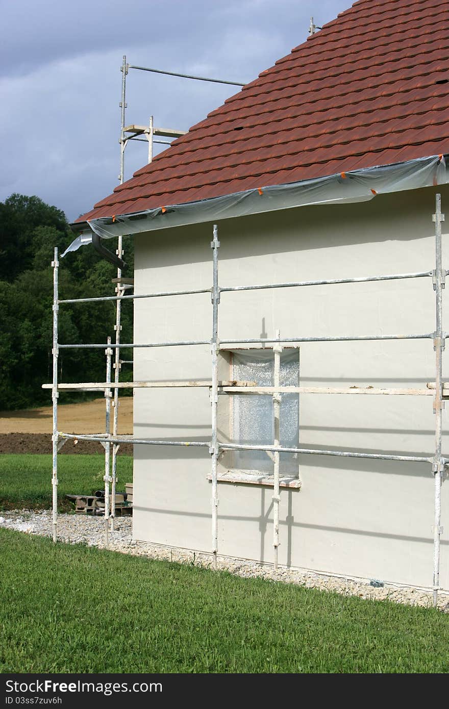 Home with a scaffold to the plaster. Home with a scaffold to the plaster