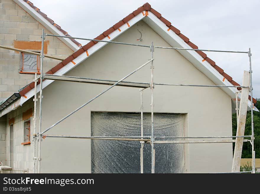 Home with a scaffold to the plaster. Home with a scaffold to the plaster