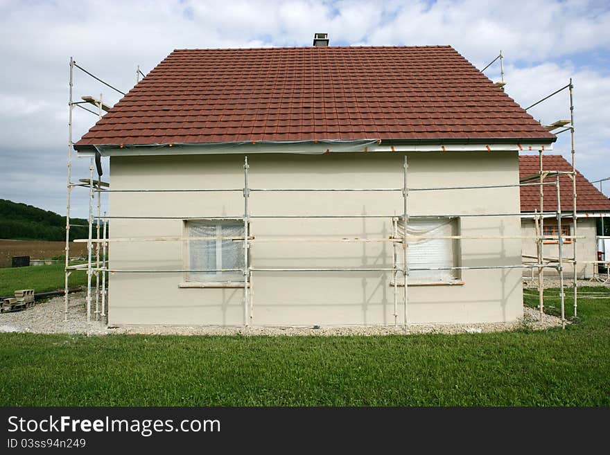 Home with a scaffold to the plaster. Home with a scaffold to the plaster