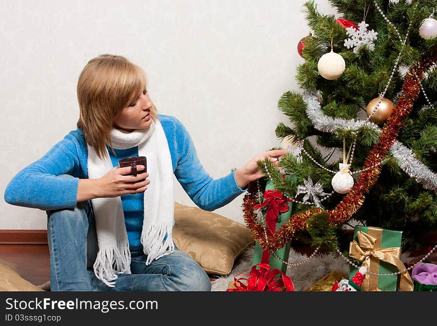 Young woman near a fir-tree