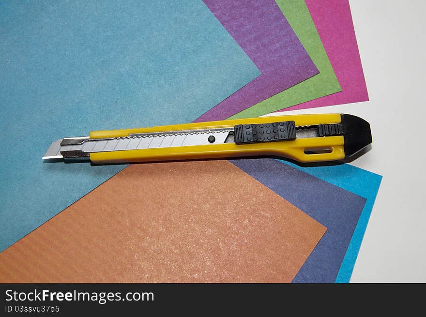 Knife for a paper on sheets of a color paper