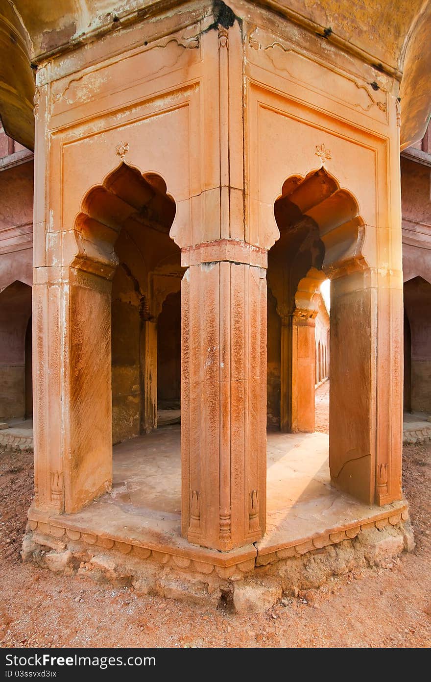 Part of ancient architecture ruins. Columns with arches constructed from terracotta stones. Part of ancient architecture ruins. Columns with arches constructed from terracotta stones