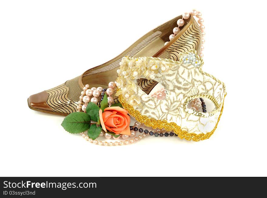 Woman golden shoe with carnival mask   on a white background. Woman golden shoe with carnival mask   on a white background