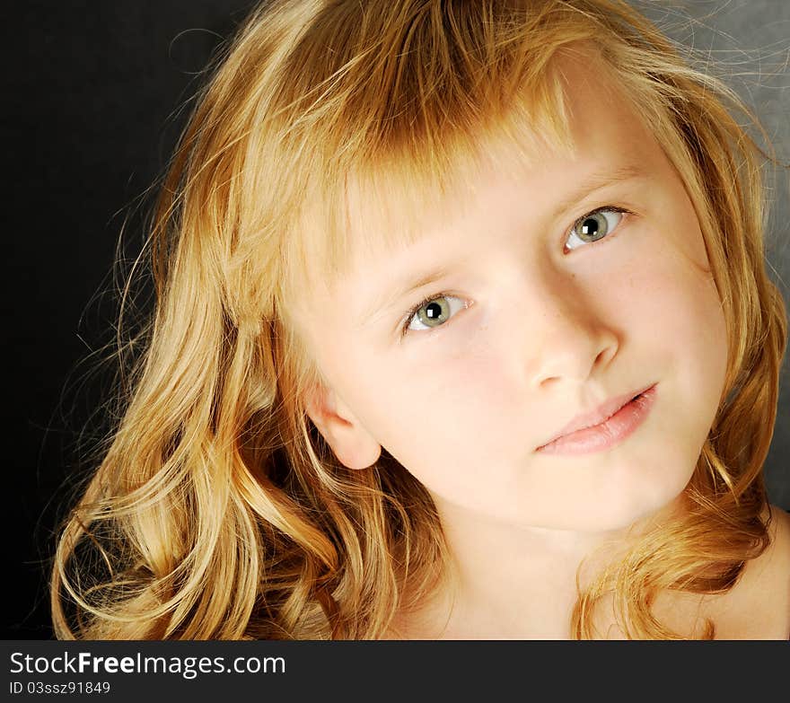 Beautiful girl with long blond hair , on a gray background. Beautiful girl with long blond hair , on a gray background