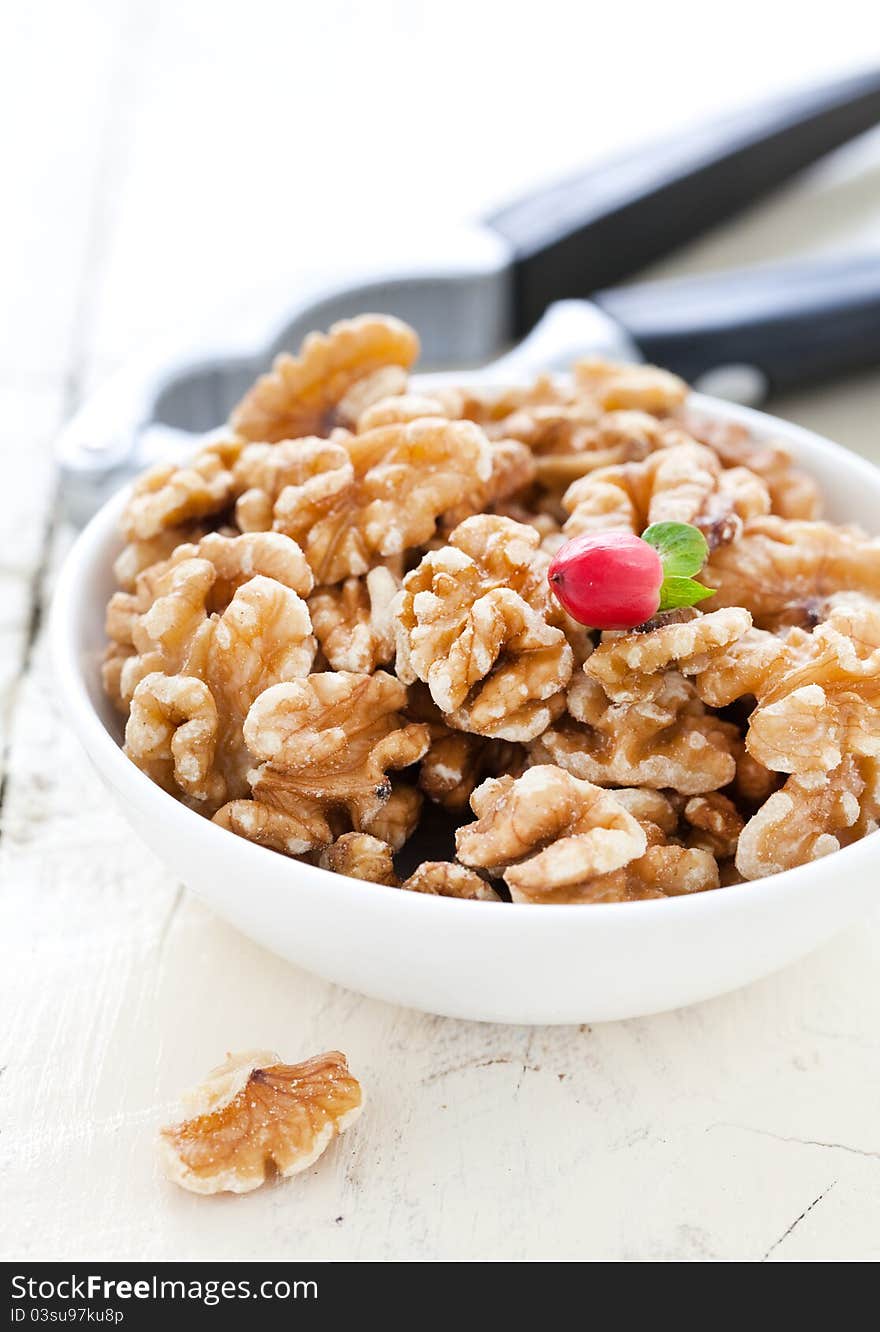 Walnuts in bowl with nutcracker