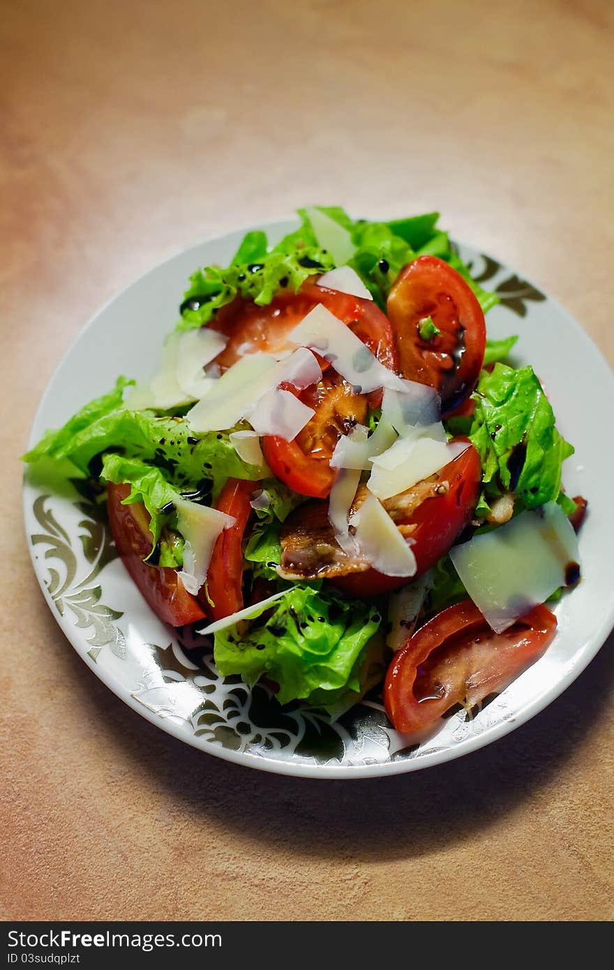 Close-up fresh salad with lettuce, tomatoes, sunflower seeds, parmesan and balsamic sauce. Close-up fresh salad with lettuce, tomatoes, sunflower seeds, parmesan and balsamic sauce