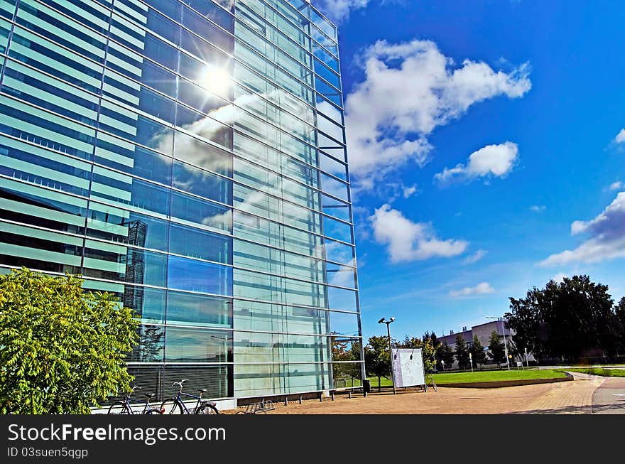 Glass building with sky and clouds reflection