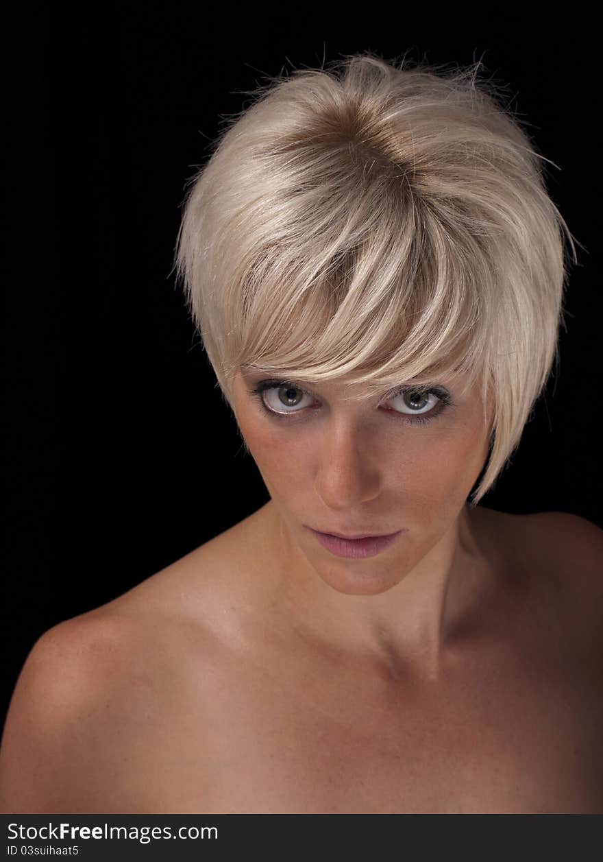 Headshot of blond model against a black background. Headshot of blond model against a black background.