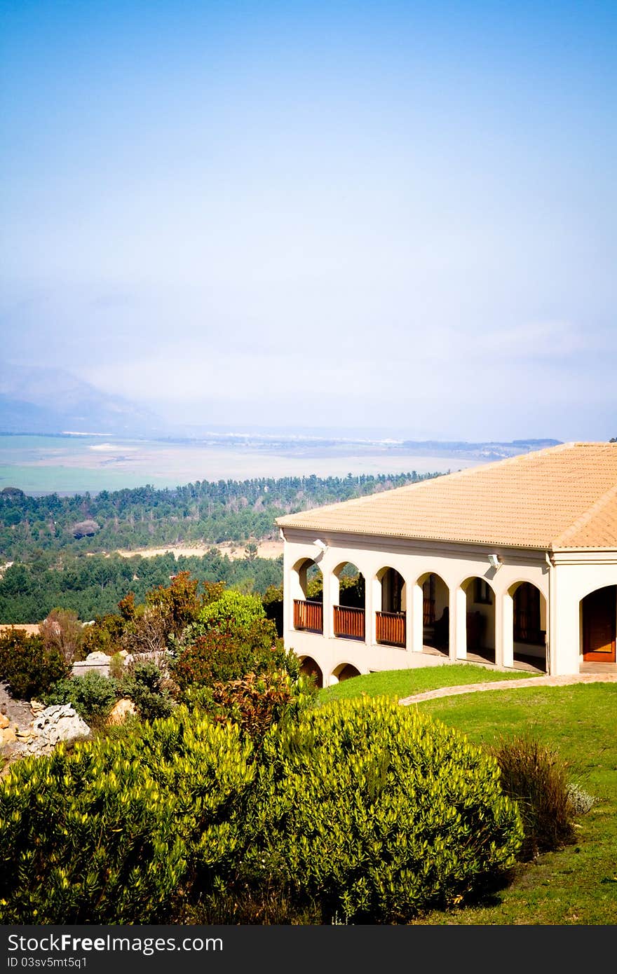 A spanish style summer villa with landscape of mountains and ocean in the distance. A spanish style summer villa with landscape of mountains and ocean in the distance