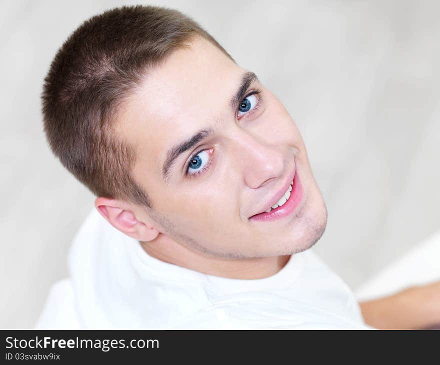 Portrait of smiling young beautiful man at home - high angle. Portrait of smiling young beautiful man at home - high angle