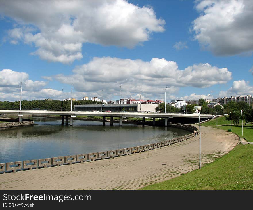 Bright cityscape one sunshine day. River bridge background.